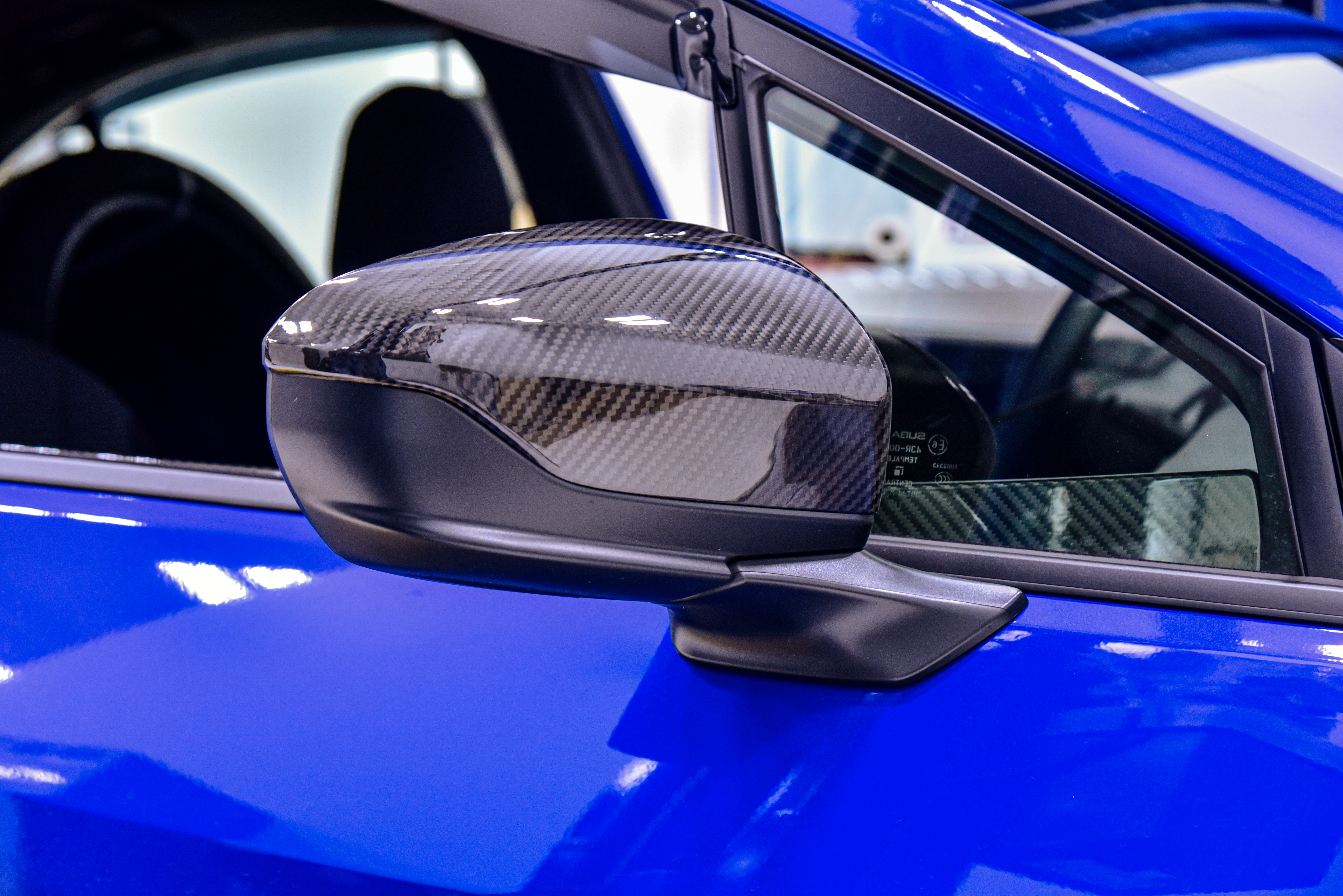 OLM Carbon Fiber Mirror Covers installed on a 2022 Subaru WRX